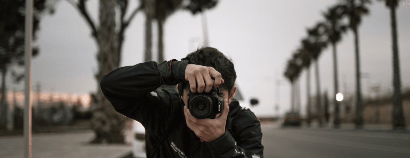 A mem clicking picture with Black DSLR Camera